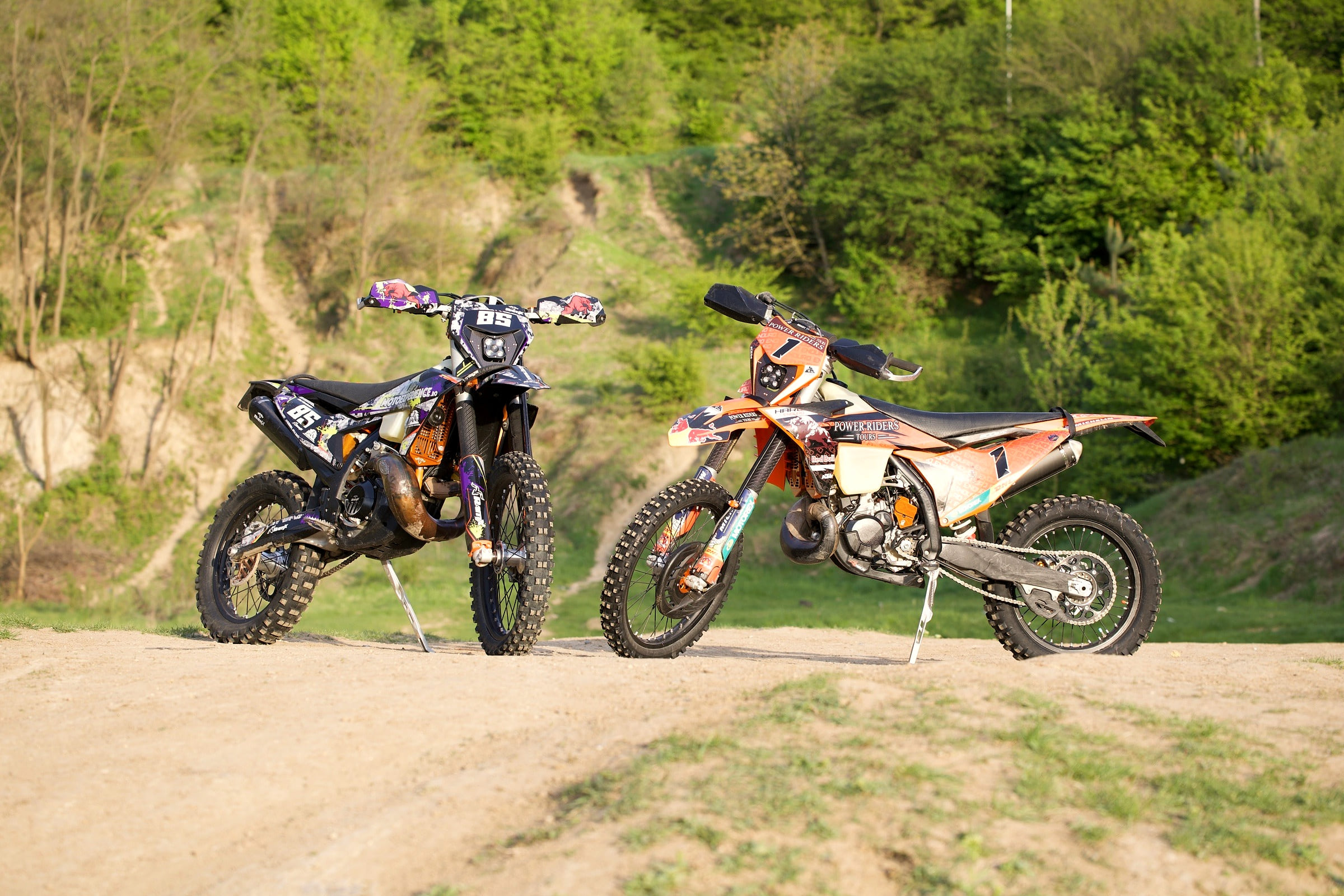 Power Riders Tours KTM 300 TBI rental bike beside a second hard enduro bike on a gravel track