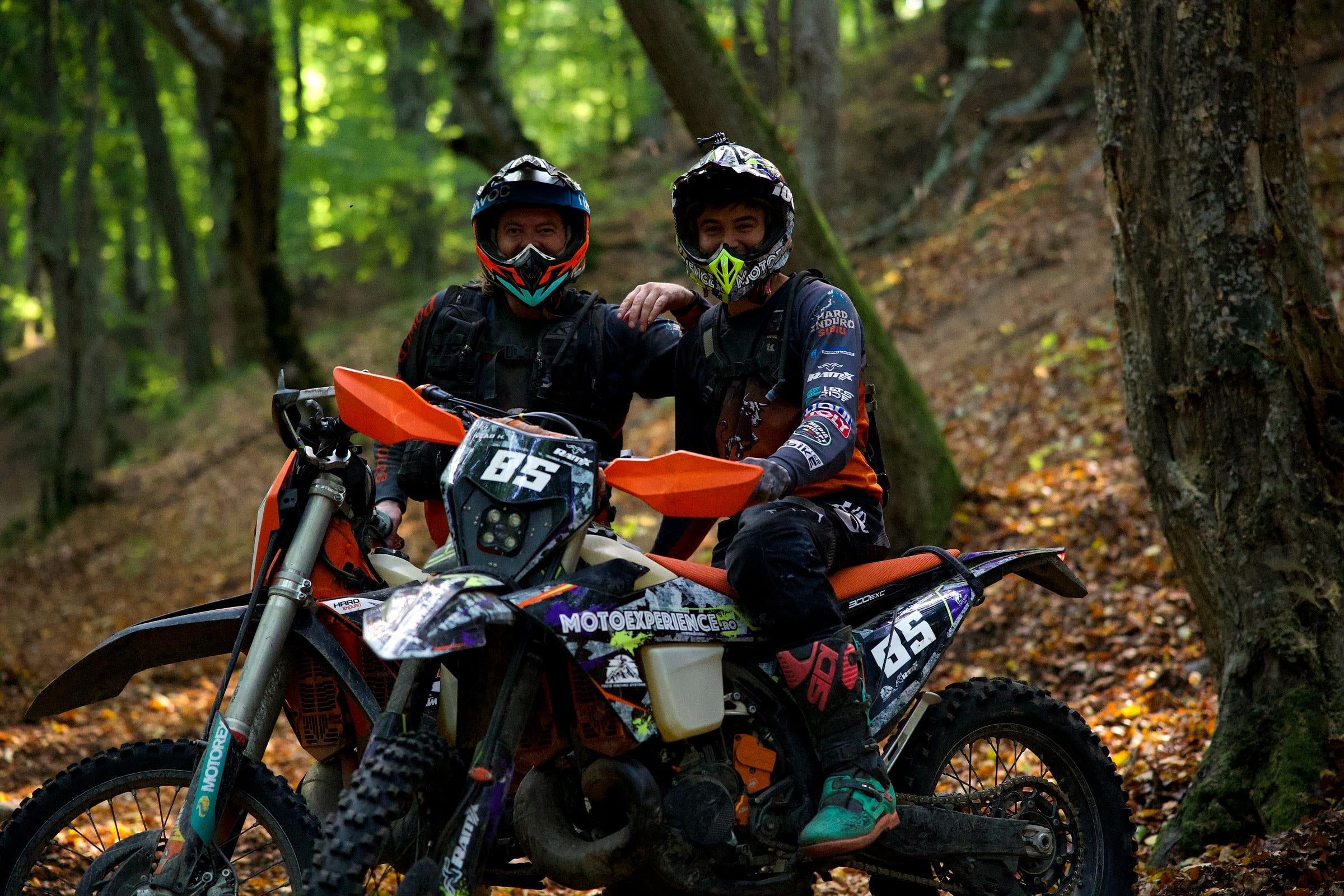 Two riders sharing a joke on the trail during a hard enduro tour