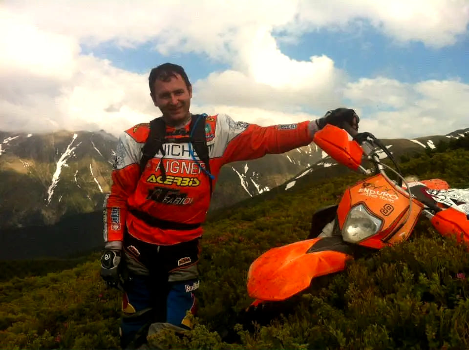 Vasile Hambasan, Vlad's father, with his enduro bike on a snowy ridge